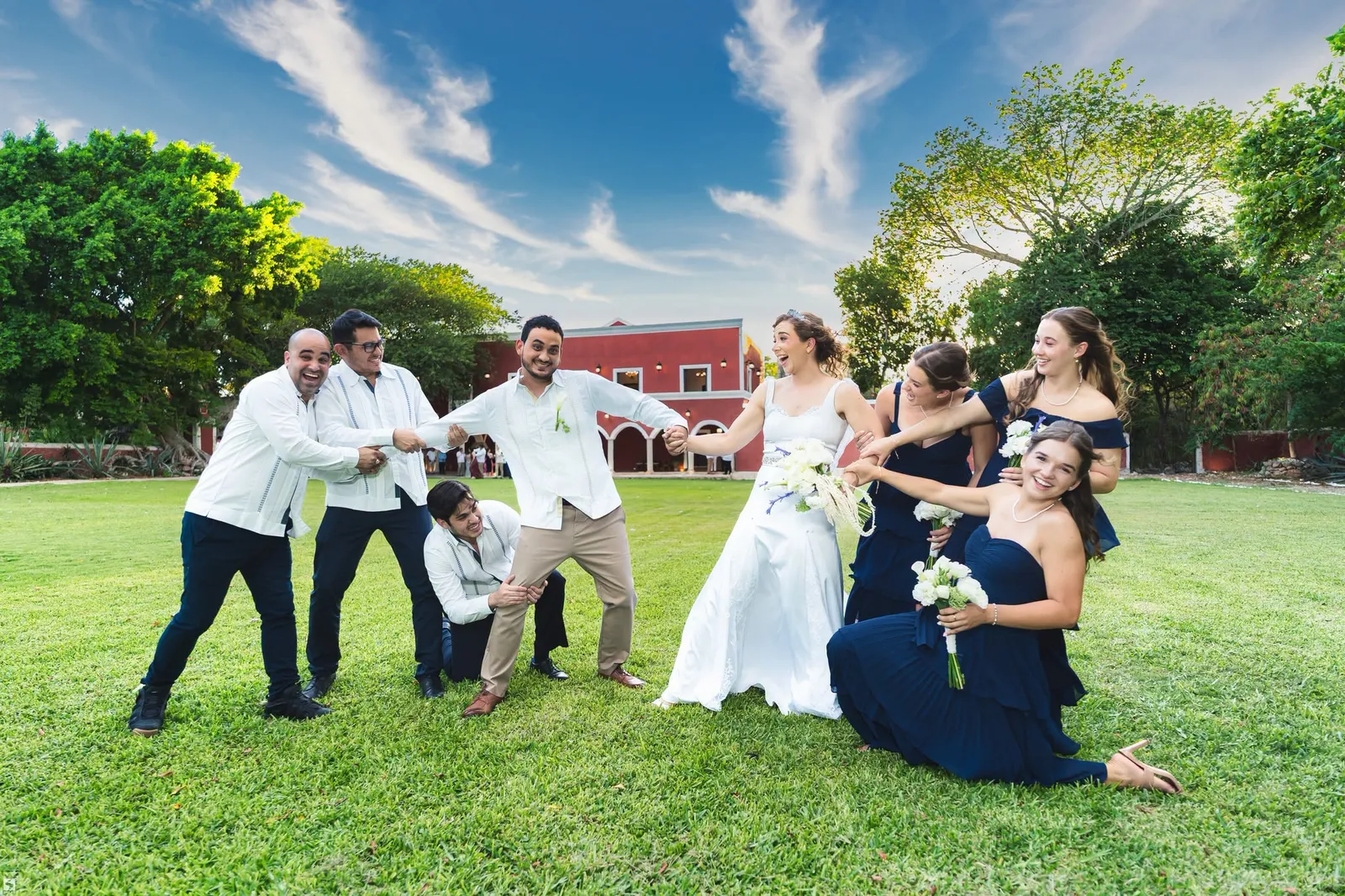 Novios con su cortejo divirtiéndose en el jardín
